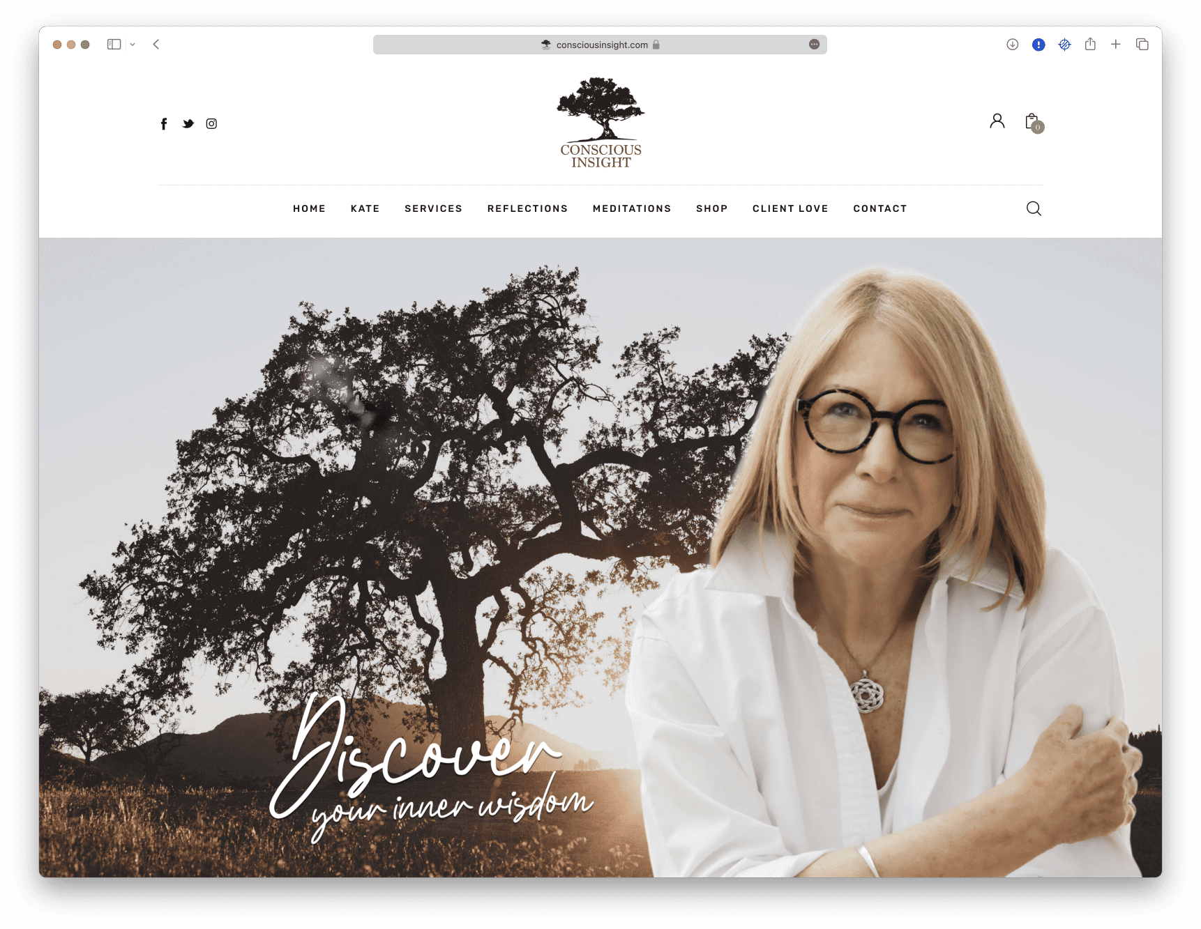 A woman in glasses is standing in front of a tree.